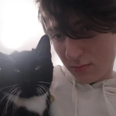 Stanisław Dymny with his tuxedo cat Tosia