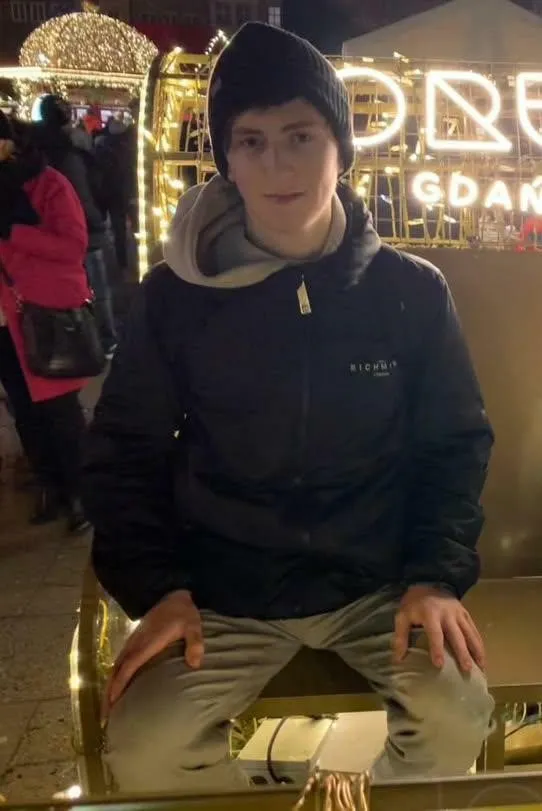 Stanisław Dymny sitting in black jacketket